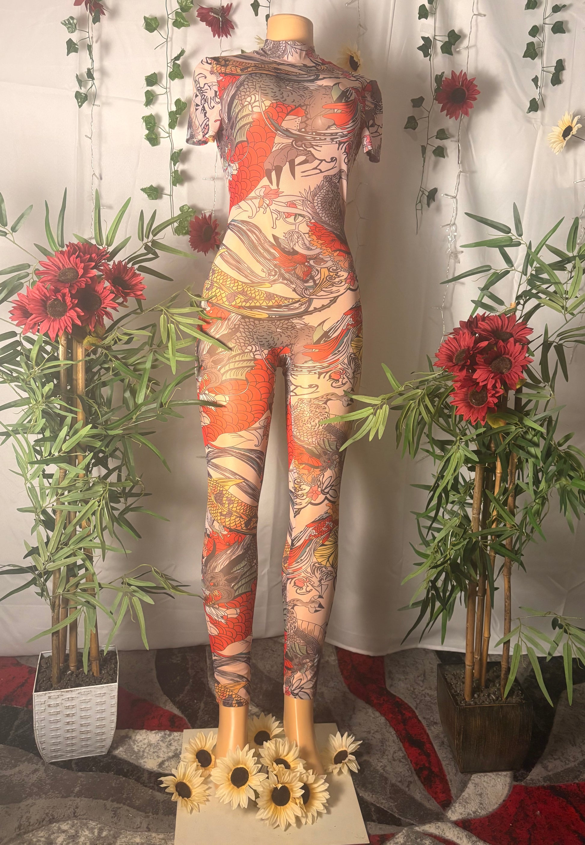 Mannequin wearing a colorful tattoo-style catsuit with decorative plants and flowers.