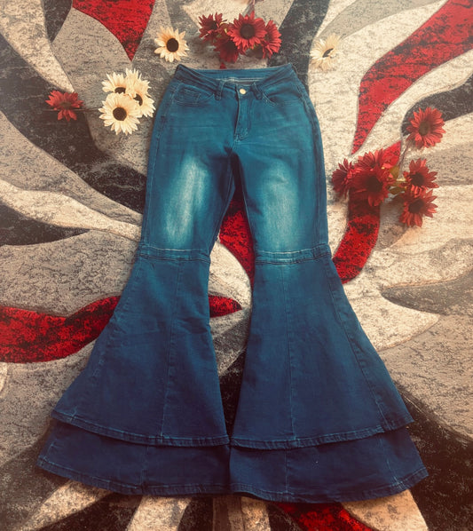 High waist flared wide leg bell-bottom pants on a textured surface with flowers