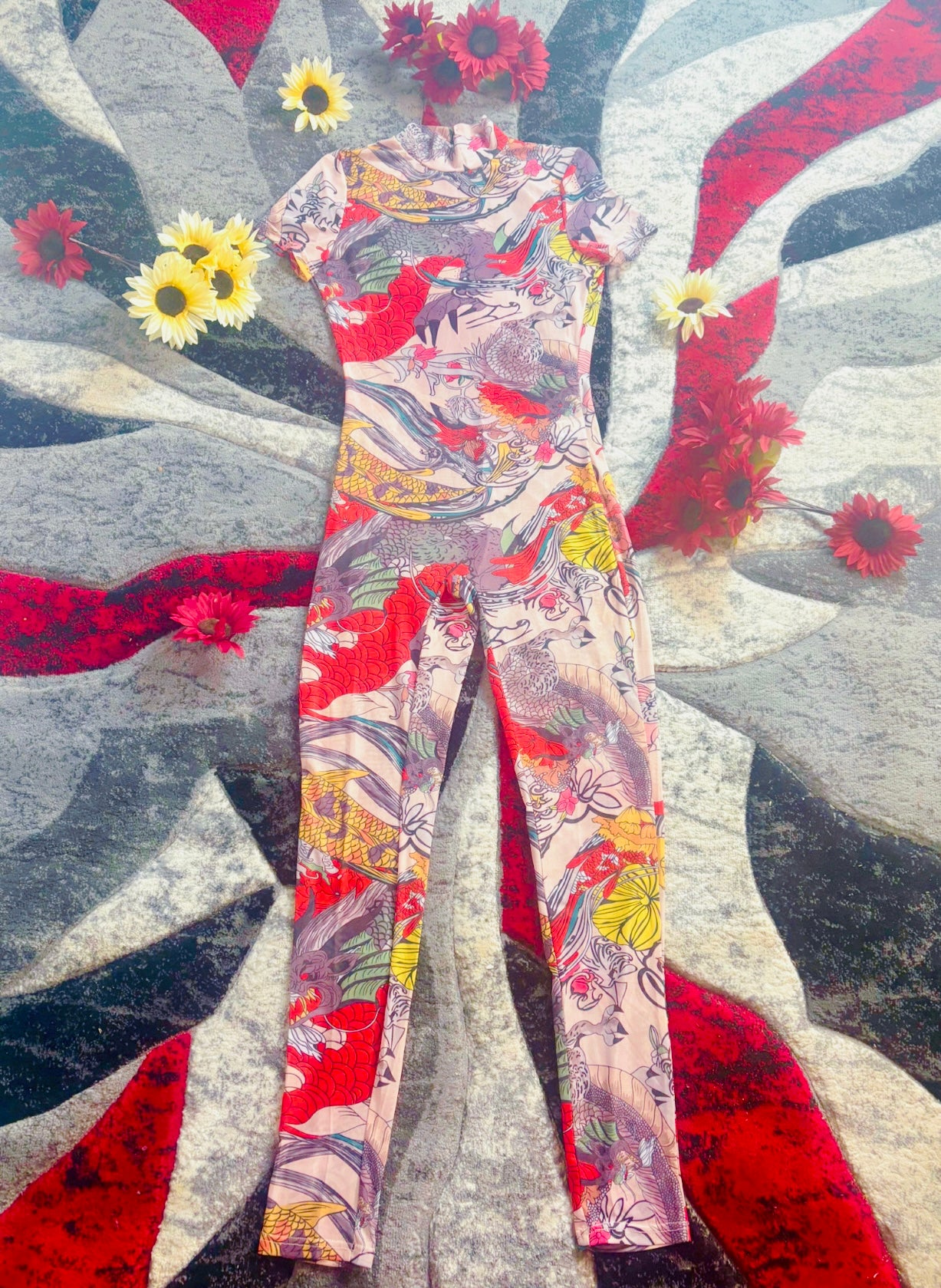 Colorful floral-patterned mesh catsuit on an abstract art background